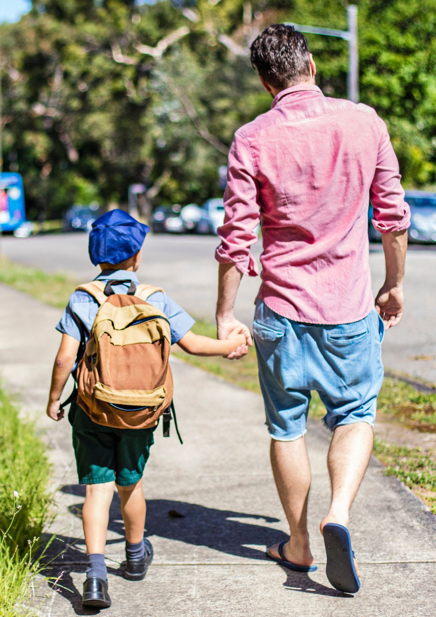 Father and Son Walking on Sidewalk