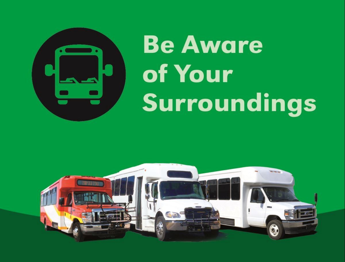 Graphic of a bus stop sign next to the words Be Aware of Your Surroundings