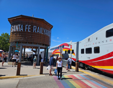 Picture of people at the Santa Fe Depot Station with the Rail Runner on the right