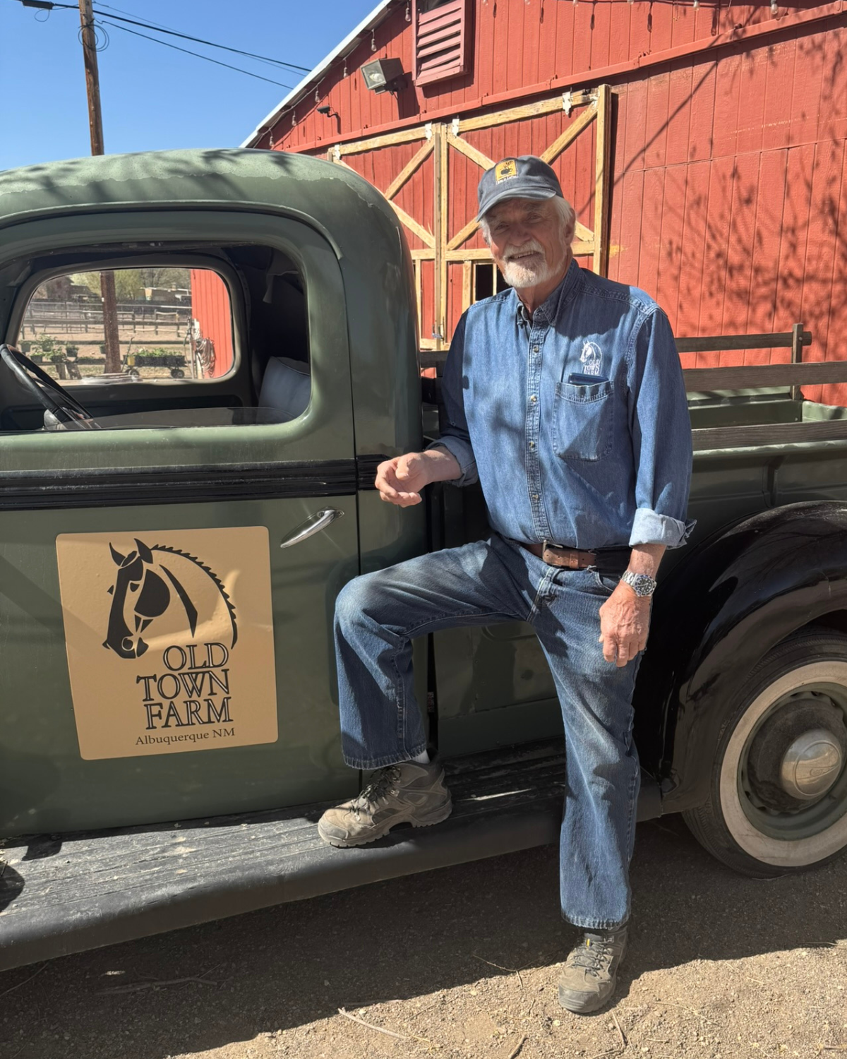 Picture of Bike In Coffee Owner Lanny Tonning standing next to an old green truck