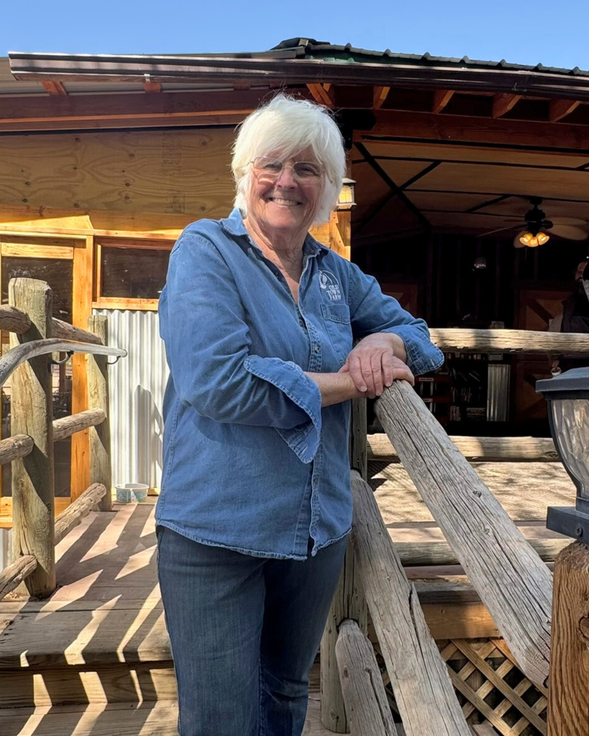 Picture of Bike In Coffee Owner Linda Thorne standing on the porch of the coffee shop