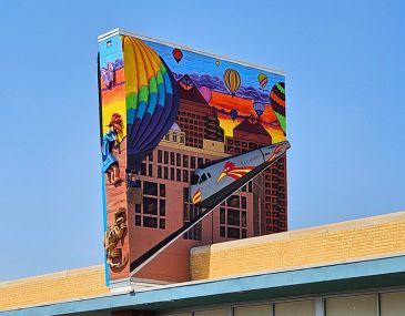 Picture of a public art mural featuring the Rail Runner train